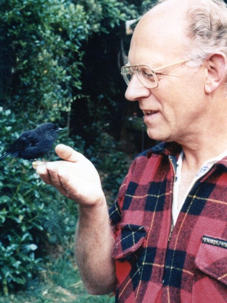 Don Merton with a Chatham Island black robin. Image supplied
