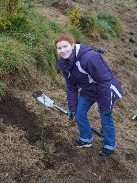 Sarah planting mānuka at the 2024 Youth Hui.