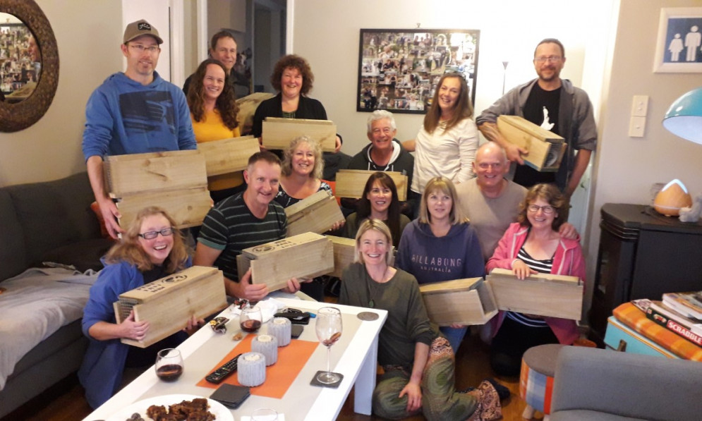 Group of Hibiscus coast volunteers holding traps in a living room