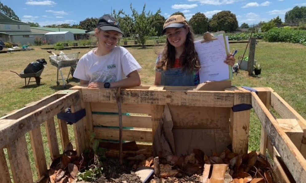 Kaitlyn and Jessica Lamb from the Bay of Plenty Forest & Bird Youth hub, working on their compost.
