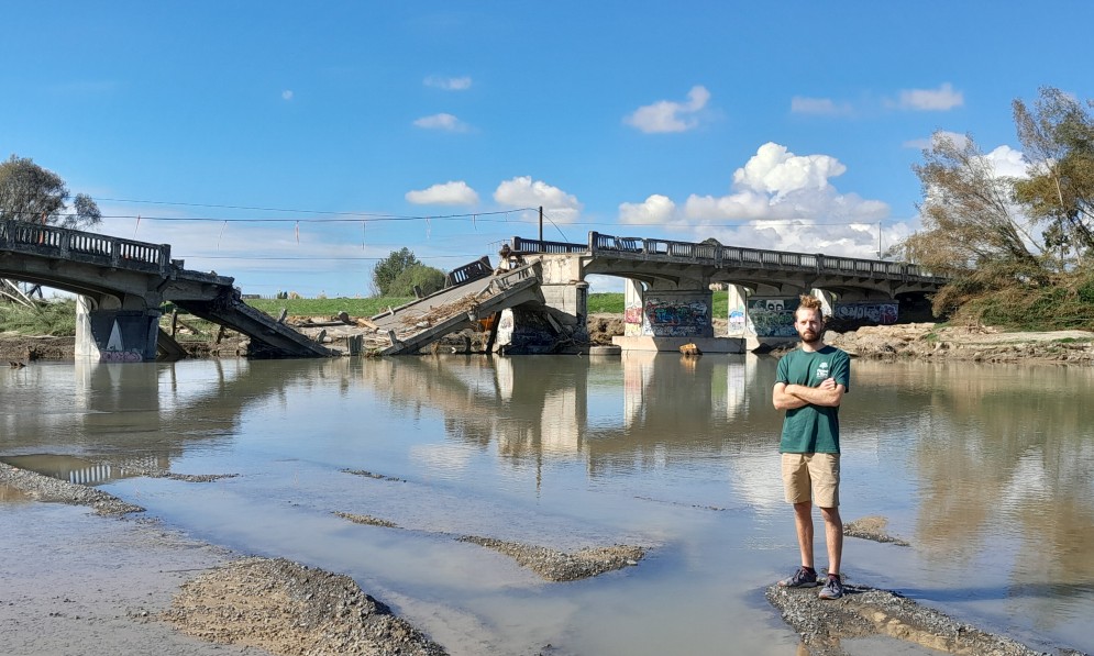 Tom Kay, Forest & Bird Freshwater Advocate, near collapsed Redclyffe Bridge after Cyclone Gabrielle damage. Image Chantal Pagel