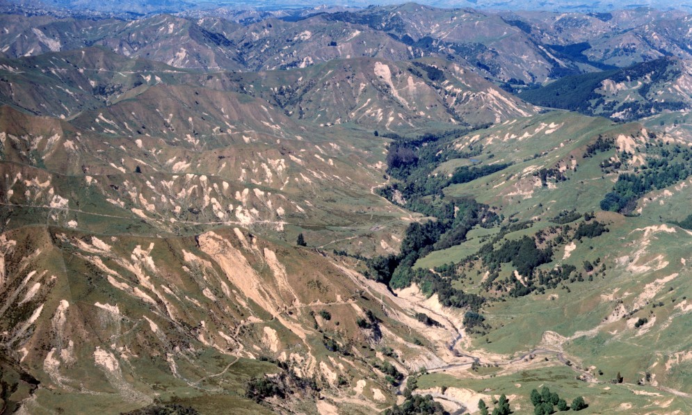 Cyclone Bola aftermath: Motumate Stream, Kaitangata Station area, looking southwest towards Te Karaka on the Waipoua River. Image: Lloyd Homer, Geological Survey. Published in Forest & Bird, November 1990.