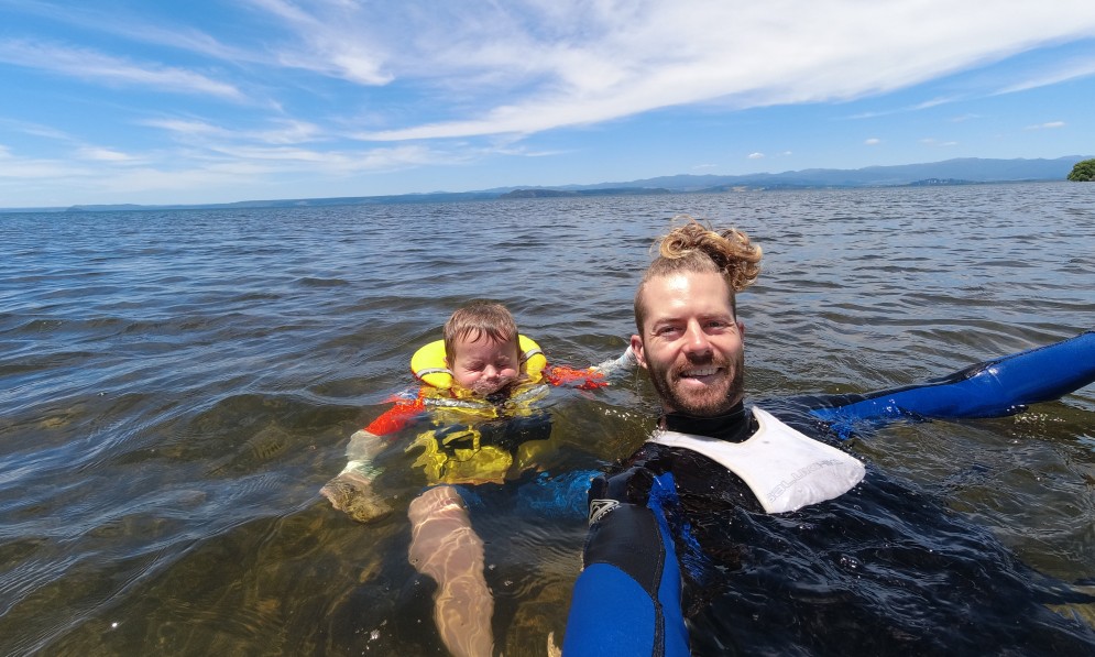 Forest & Bird’s freshwater advocate, Tom Kay, swimming with his nephew Riley, Lake Taupō, 2023. Image supplied