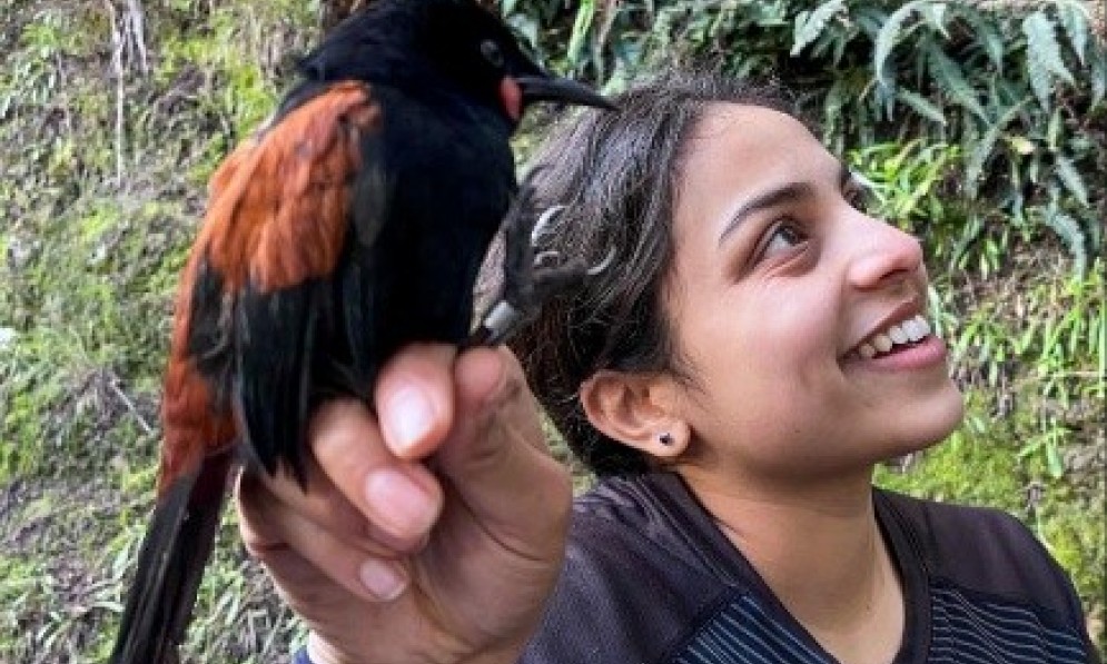 Kamya Patel holding a saddleback bird.
