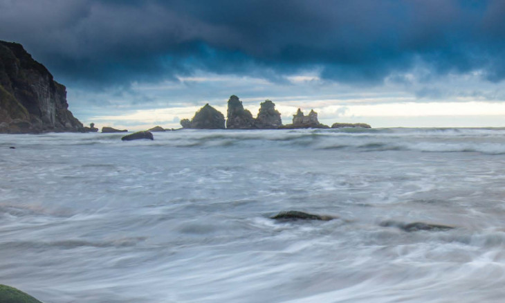 Dark and moody landscape of the ocean from a shore