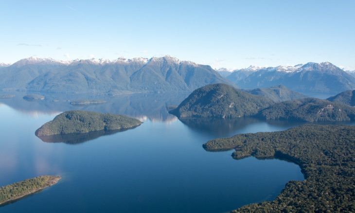 Lake Manapōuri with forest covered hills from above