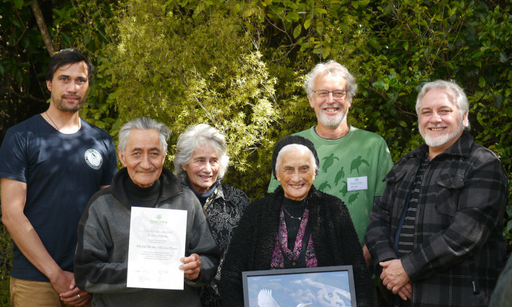 Motiti Rohe Moana Trustees stand together with award.