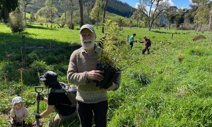 Volunteer (Budyong) holding a planting during the 2022 Ronga planting day