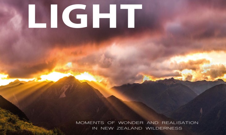 Picture of clouds, rays of sun, over mountains