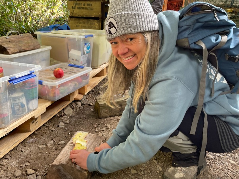 Esther Remnant chopping up an apple to use in traps as possum bait.